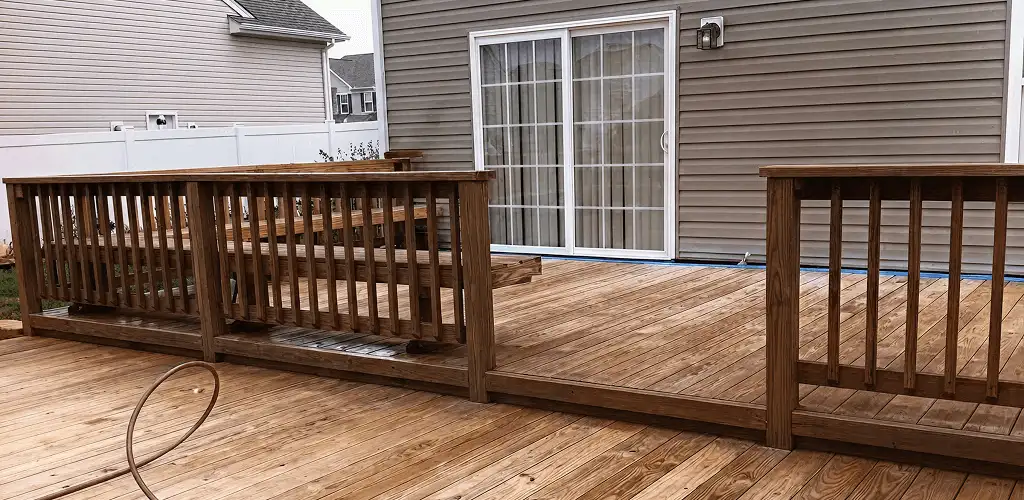 Deck sealing service protecting a backyard wood deck and railings in Boulder, CO