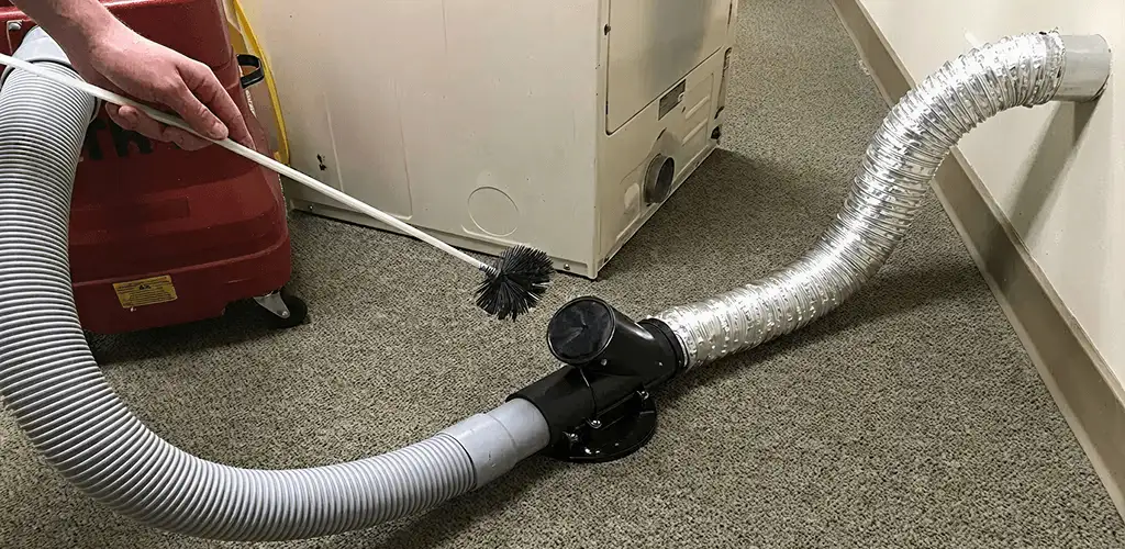 Dryer vent cleaning service removing lint from a dryer duct connection in Boulder, CO