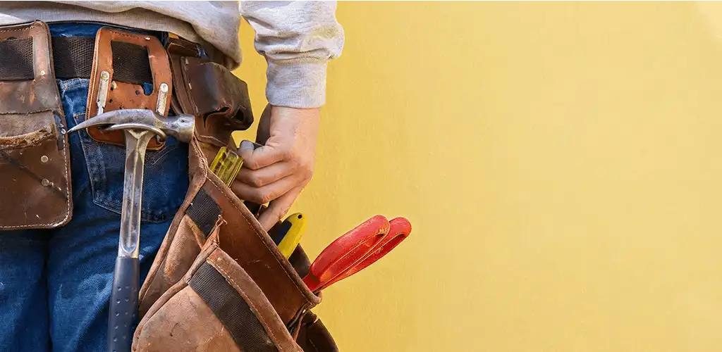 Handyman with tool belt ready for home repairs and maintenance in Boulder, CO