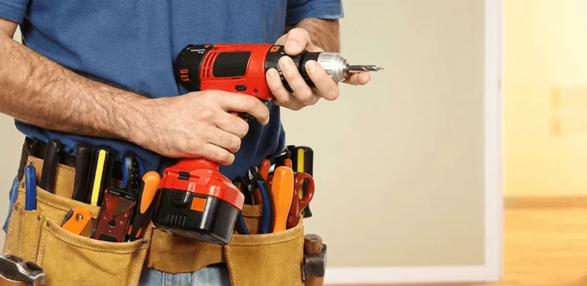 Handyman holding a power drill for home repairs and installations in Boulder, CO