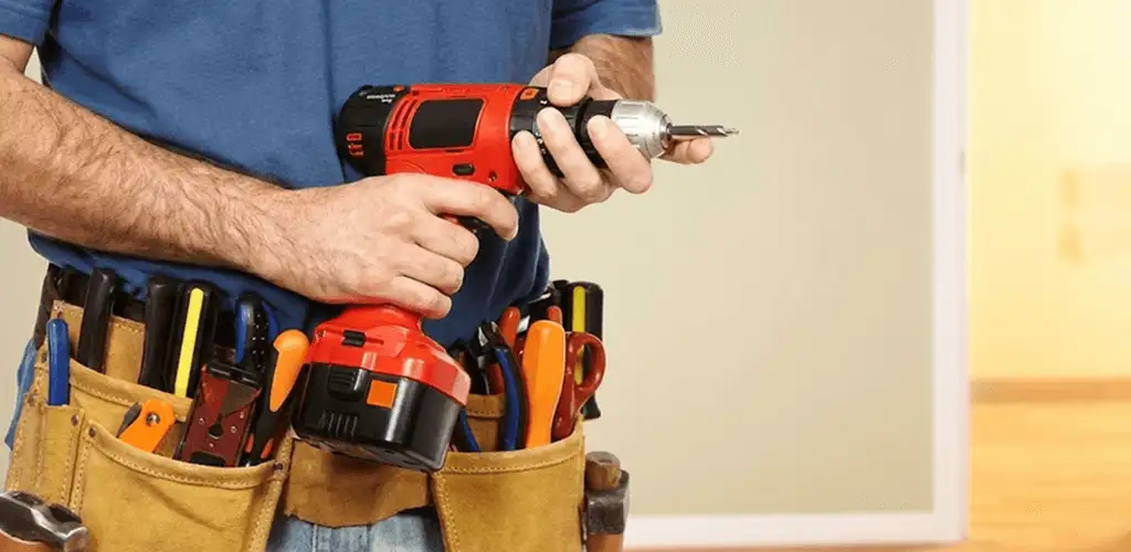 Handyman holding a power drill for home repairs and installations in Boulder, CO