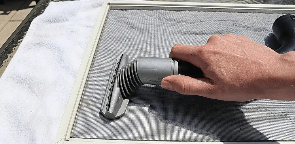 Window screen repair cleaning and fixing a damaged screen mesh in Boulder, CO