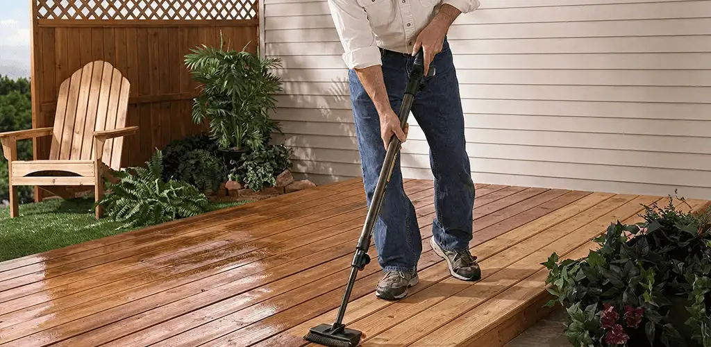 Deck staining service applying stain to a backyard wood deck in Boulder, CO